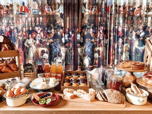 a table filled with different types of bread and pastries at MOB HOTEL Lyon Confluence in Lyon