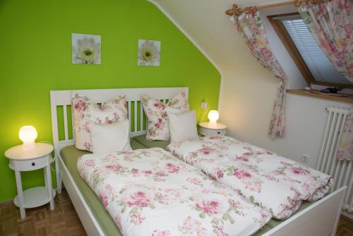 1 Schlafzimmer mit 2 Betten und einer grünen Wand in der Unterkunft Ferienwohnung Hortensie in Markdorf