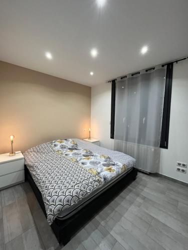 a bedroom with a large bed in a room with windows at Logement privé à proximité du Mont Ventoux in Carpentras