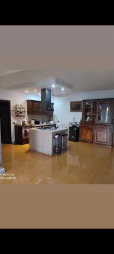 a large kitchen with wooden cabinets and a tile floor at La villa di Lucio in Marino