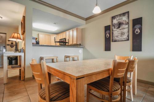 a kitchen and dining room with a wooden table and chairs at MVC - Unit 2602 - Sweet Serenity in Pigeon Forge