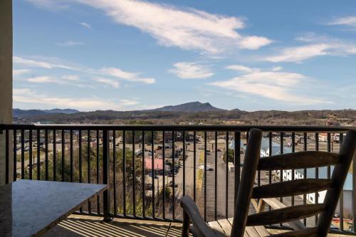 a balcony with two chairs and a table and a view at MVC - Unit 1601- Sweet Butterfly in Pigeon Forge