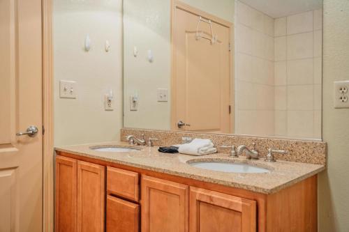 a bathroom with two sinks and a large mirror at MVC - Unit 3606 in Pigeon Forge