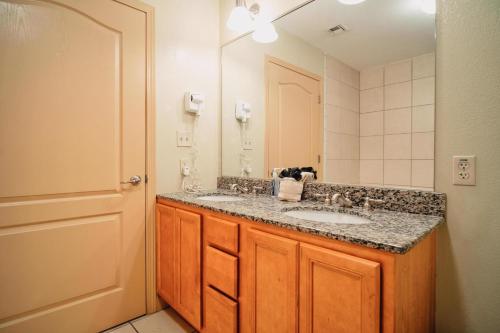a bathroom with two sinks and a large mirror at MVC - Unit 1305 in Pigeon Forge