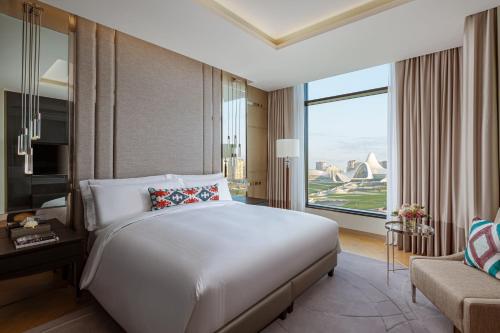 a hotel room with a bed and a large window at The Ritz-Carlton, Baku in Baku