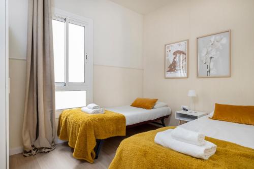 um quarto com 2 camas e uma janela em Apartments Sata Sagrada Familia Area em Barcelona