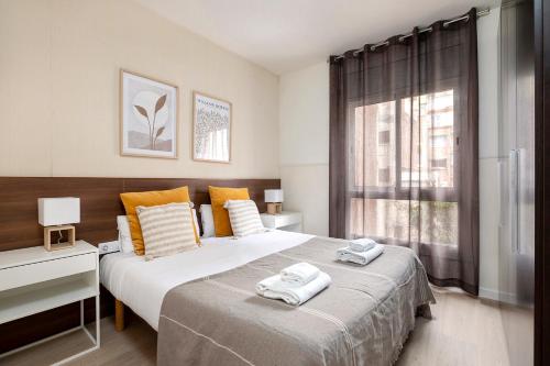 a bedroom with two beds with towels on top of them at Apartments Sata Sagrada Familia Area in Barcelona