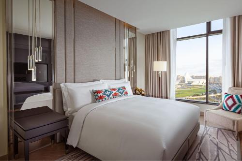 a bedroom with a large white bed and a window at The Ritz-Carlton, Baku in Baku