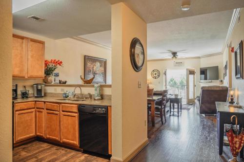 a kitchen with a black dishwasher and a dining room at MVC - Unit 3207 - Happy Place in Pigeon Forge