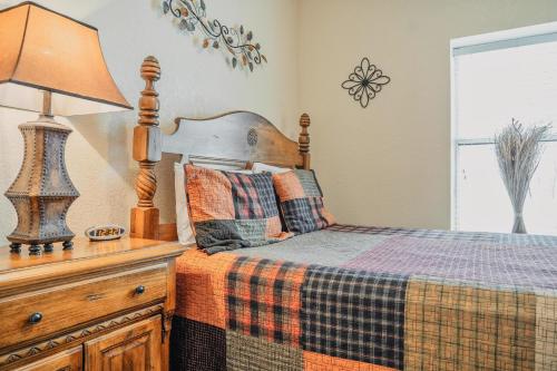 a bedroom with a bed and a lamp on a dresser at MVC - Unit 3207 - Happy Place in Pigeon Forge