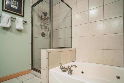 a bathroom with a bath tub and a shower at MVC - Unit 1405 - Bears Lair in Pigeon Forge