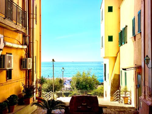 a view of the ocean from between two buildings at Artis Mare in Pozzuoli