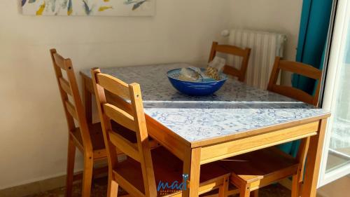 a table with a blue bowl on top of it at Madò Apartments Egnazia in Bari