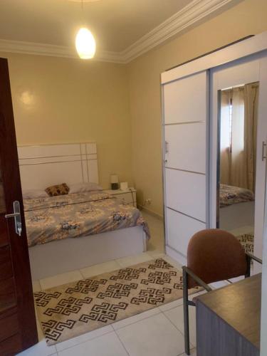 a bedroom with two beds and a sliding glass door at Résidence Hadja 02 in Dakar