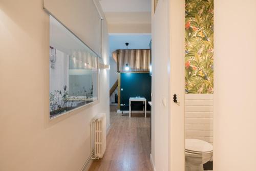 a hallway with a toilet and a table at Aguirre apartment by People Rentals in Bilbao