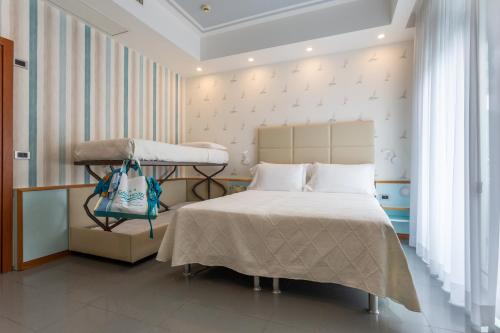 a hospital room with a bed and a crib at Hotel Gaby in Rimini