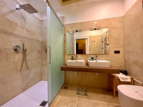 a bathroom with two sinks and a shower at Casa Santangelo Suites in Salerno