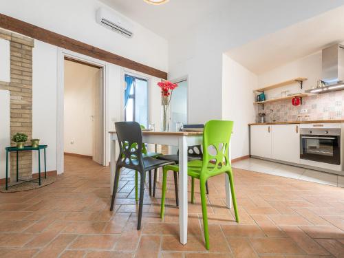 a kitchen and dining room with a table and chairs at Santa Margherita House in Cagliari