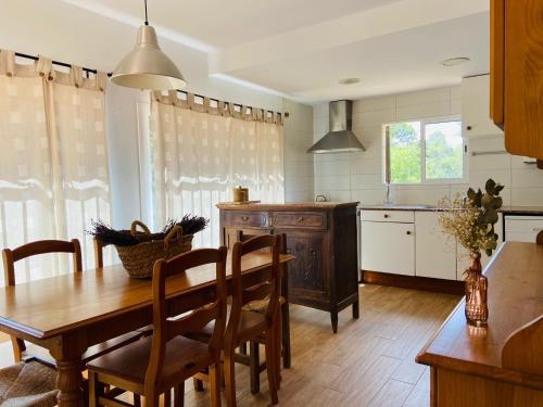 uma cozinha com uma mesa de madeira e uma sala de jantar em Refugio en el Parque natural del Montseny 