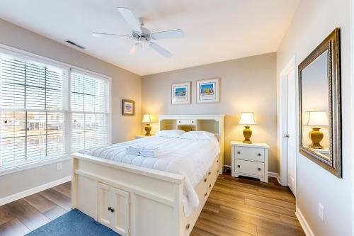 a bedroom with a white bed and a window at The Tides -- 20007 Sandy Bottom # 4202 in Rehoboth Beach