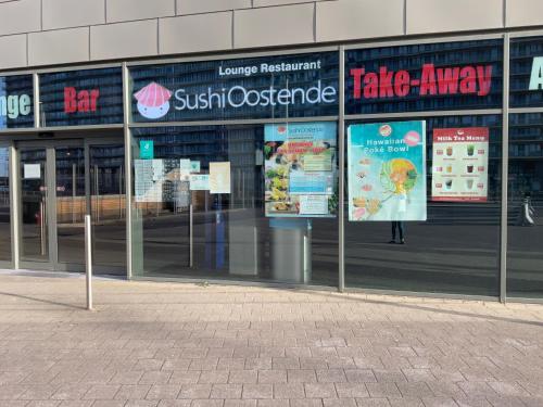 a building with signs on the side of it at Micheline's plekje in Ostend