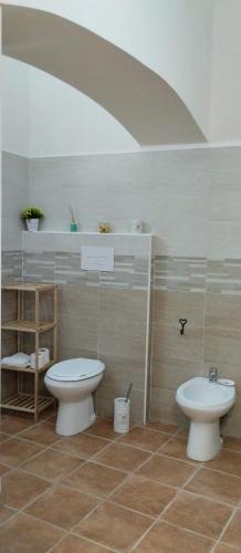 a bathroom with a toilet and a sink at La Casa di Amelia in Ruviano