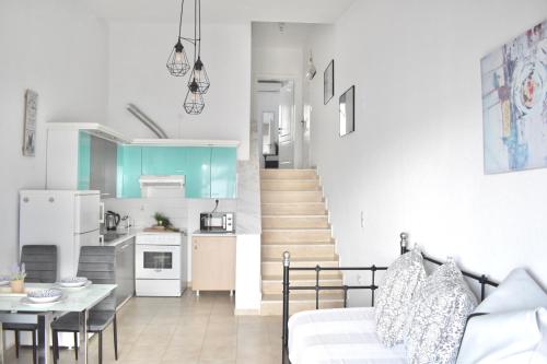 a kitchen and living room with a couch and a table at Varonos Summer Residences in Siviri