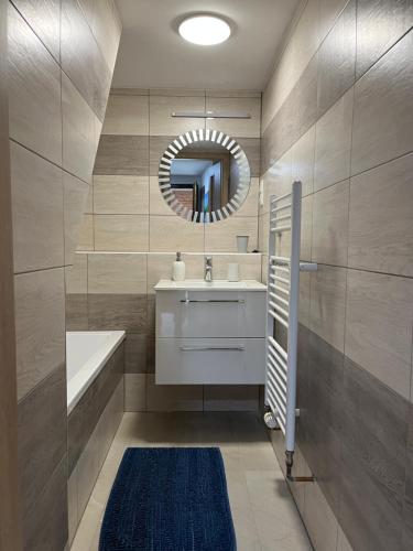 a bathroom with a sink and a mirror at Apartments Badallee 4 in Bad Schandau