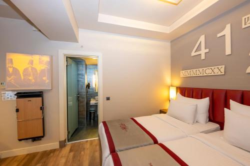 a hotel room with a bed and a bathroom at Ramada By Wyndham Istanbul Pera Taksim in Istanbul