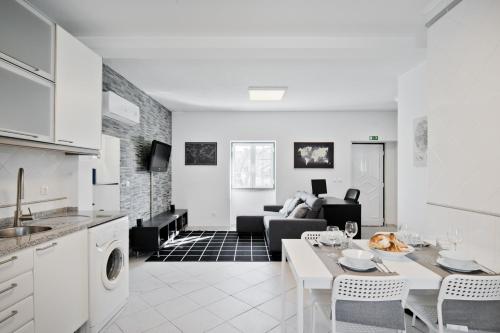 a kitchen and living room with a couch and a table at BmyGuest - Cascais Beach Villa I in Cascais