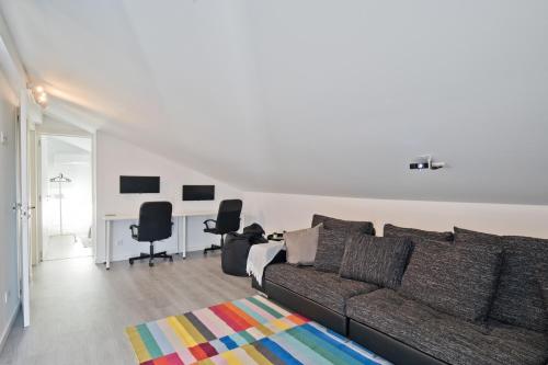 a living room with a couch and two chairs at BmyGuest - Cascais Beach Villa II in Cascais