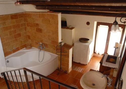 a bathroom with a large tub in a room at CASALE SPOLETO in Spoleto