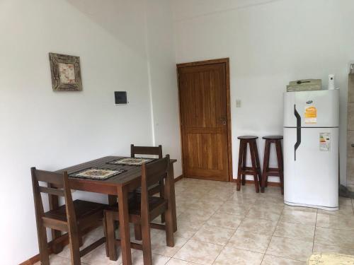 a kitchen with a table and a refrigerator at Departamento de Magui en Montecarlo in Montecarlo