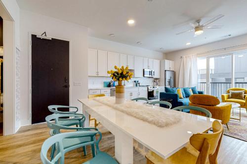 a kitchen and living room with a table and chairs at Jolene on Main 402 in Nashville