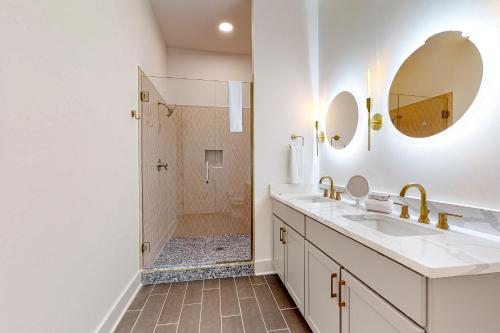 a bathroom with a shower and a sink and mirror at Jolene on Main 402 in Nashville