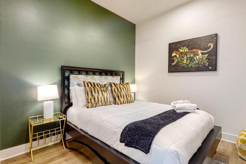 a bedroom with a bed with a green wall at Jolene on Main 402 in Nashville