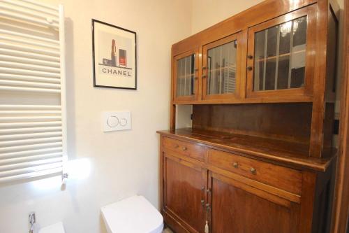 uma casa de banho com um armário de madeira e um WC em Case VR Holiday Vittorias Flat em Verona