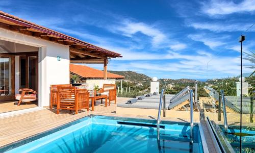 a villa with a swimming pool and a patio at Villa Carolina Private Pool in Agios Nikolaos