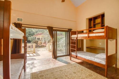 a room with bunk beds and a balcony at Villa Fiesta at Morningstar Breeze Gold Standard Certified in Hopkins