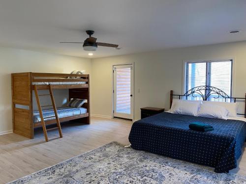 a bedroom with a bed and a bunk bed at Waterfront w Private Dock, Luxurious & Cozy, Deerfield Resort in Alder