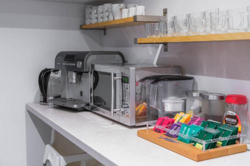 a coffee maker on a counter in a kitchen at Willa Jelitkowska in Gdańsk
