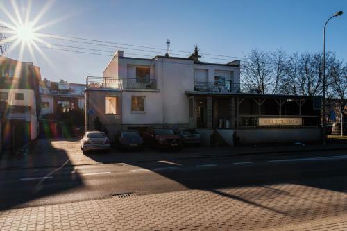 a street with cars parked in front of a building at Willa Jelitkowska in Gdańsk