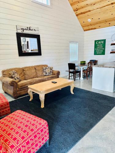 a living room with a couch and a table at Knotty Squirrel Cabins in Mountain View