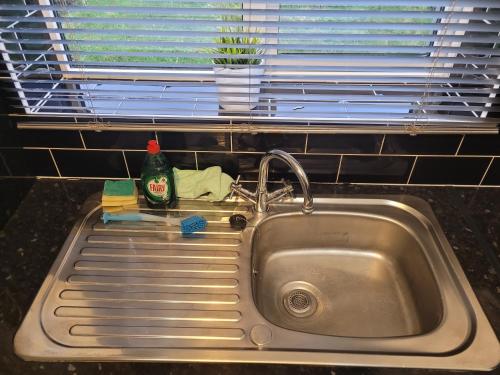 a sink in a kitchen with a window at Rent Unique the Otford modern home 1 bed with mezzanine in Crawley