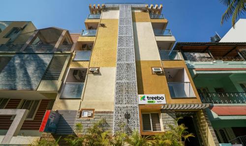 a tall building with a sign on it at Treebo Trend Elite 7 in Bangalore