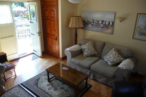 a living room with a couch and a coffee table at Beech Farm cottages in Tetney