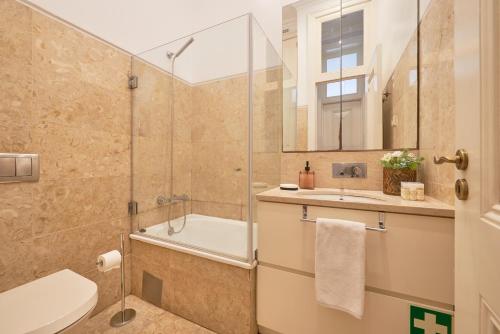 a bathroom with a shower and a toilet and a sink at Casa Portuguesa Prata in Lisbon