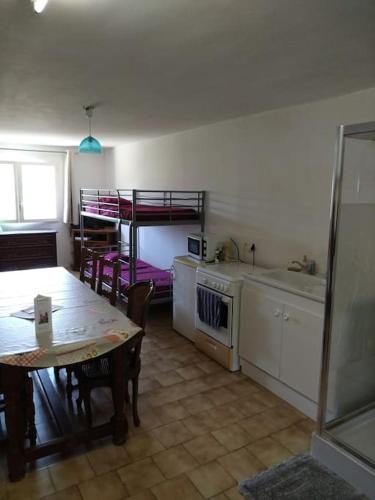 Il comprend une cuisine avec une table et des lits superposés. dans l'établissement La chambre de Bacchus Studio avec parking entre plage et centre ville, à Saint-Cyr-sur-Mer