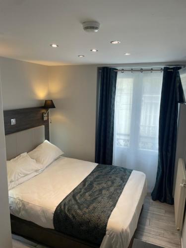 a bedroom with a bed and a window at Mary's Hotel République in Paris