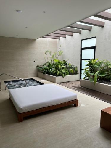 a bedroom with a bed and some plants at Tucan Resort & Spa in Paramaribo